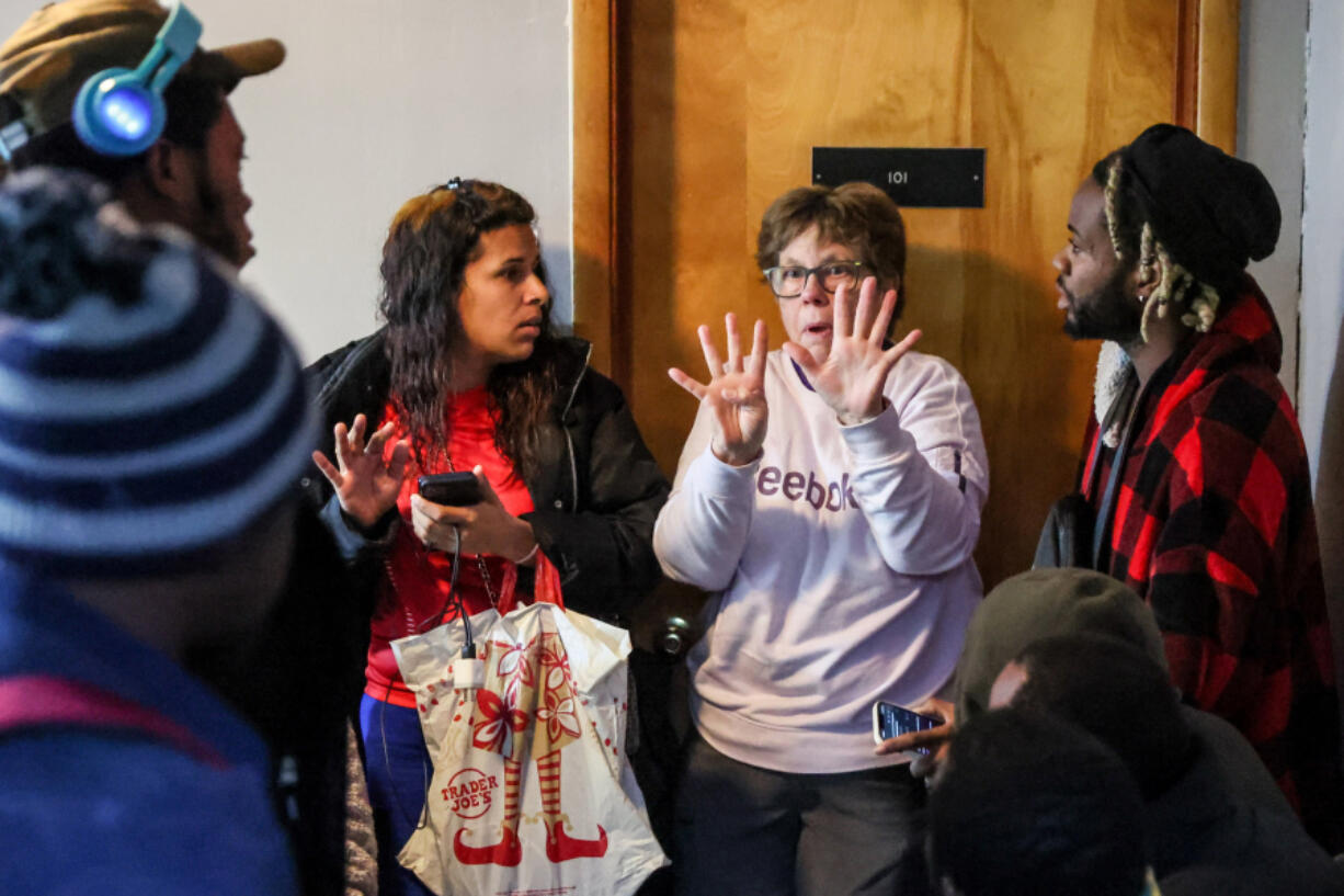 The Rev. Jan Bolerjack announces Dec. 5 at Riverton Park United Methodist Church in Tukwila that the local housing office will reopen in the morning.