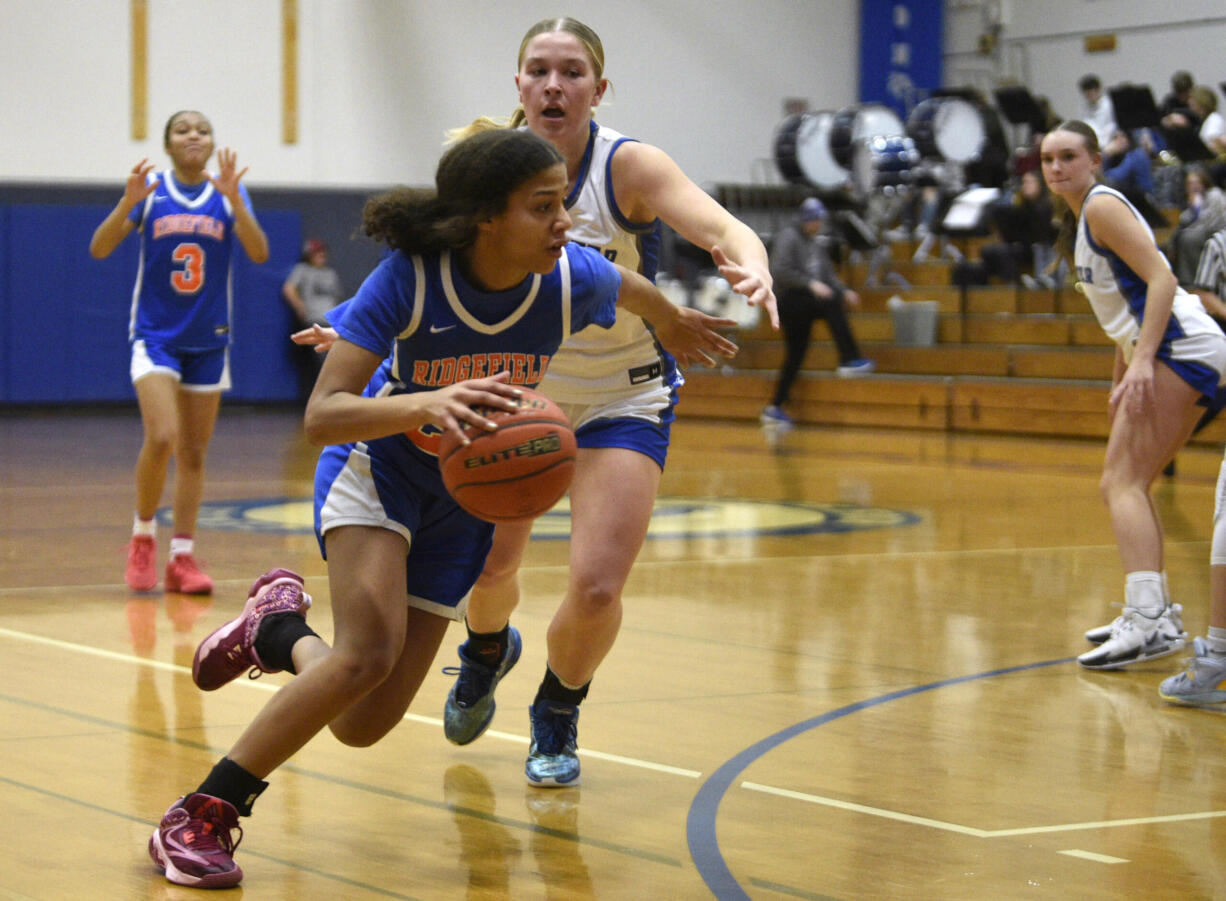 Ridgefield’s Jalise Chatman spins and drives toward the basket during a non-league girls basketball game against La Center on Monday, Dec. 18, 2023, at La Center High School.