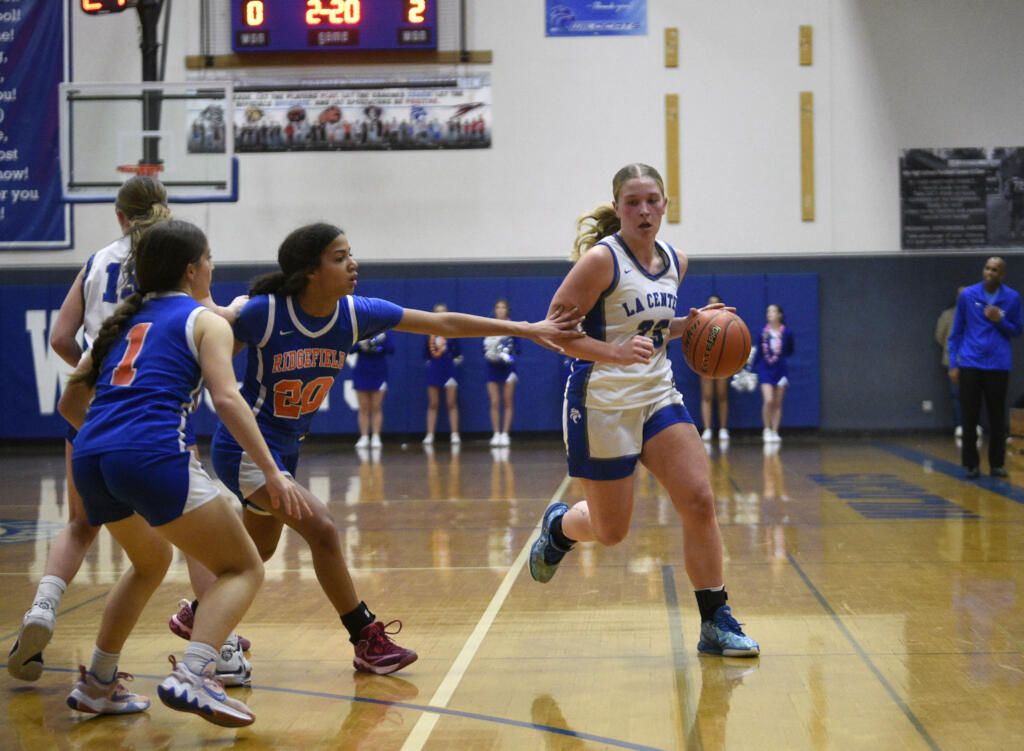 La Center’s Mekenzie Schockelt dribbles around a screen during a non-league girls basketball game against Ridgefield on Monday, Dec. 18, 2023, at La Center High School.