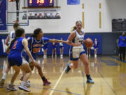 La Center’s Mekenzie Schockelt dribbles around a screen during a non-league girls basketball game against Ridgefield on Monday, Dec. 18, 2023, at La Center High School.