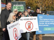 Let&Ccedil;&fnof;&Ugrave;s Go Washington founder Brian Heywood, left, poses with supporters following a press conference about state ballot initiatives, including Initiative 2117, at Jackson&Ccedil;&fnof;&Ugrave;s Shell Station in Kent.