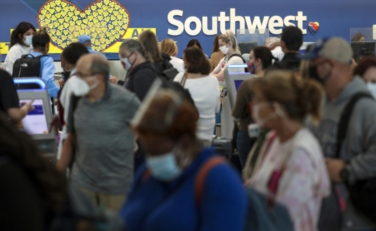 Travelers wait to check in at the Southwest Airlines ticketing counter at Baltimore Washington International Thurgood Marshall Airport on Oct. 11, 2021, in Baltimore.