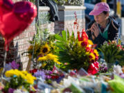 Shally, whose dance partner died in the shooting and who witnessed the shooting, pays her respects at a makeshift memorial for victims of the mass shooting outside Star Ballroom Dance Studio on Jan. 24, 2023, in Monterey Park, California.