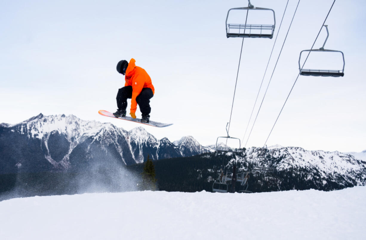 Jon Blue spins a backside-360 underneath Chair 8, which was not running yet Dec. 13, during opening day at Mt. Baker Ski Area.