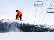 Jon Blue spins a backside-360 underneath Chair 8, which was not running yet Dec. 13, during opening day at Mt. Baker Ski Area.