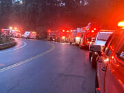 First responders line Hazel Dell Avenue on Thursday morning while rescue crews work to help an injured woman who&rsquo;d fallen down an embankment. The woman was taken to an area hospital with not life-threatening injuries.