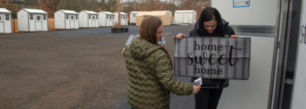 The third Safe Stay location opens in November at 415 W. 11th St. in downtown Vancouver. Outsiders Inn outreach team members Crystal Drake, in black, and Jammie Havens, in green, put out welcome mats at the pallet shelters.