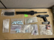 Suspected fentanyl pills and illegally owned guns investigators seized from a motel room in connection with a drug investigation Thursday during an area-wide stolen vehicle sting. The suspected owner, a 35-year-old Vancouver man, was one of several people arrested during the operation.