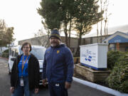 Elizabeth Cochran, left, and Ace Salu of Columbia River Mental Health Services take a break with the clinic&rsquo;s new community response team van on Friday afternoon.