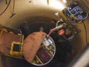 In this image provided by the U.S. Air Force, Airman 1st Class Jackson Ligon, 341st Missile Maintenance Squadron technician, examines the internals of an intercontinental ballistic missile during a simulated electronic launch Minuteman test Sept. 22, 2020, at a launch facility near Malmstrom Air Force Base in Great Falls, Mont. The Air Force has determined that cancer data recorded in health records of service members who worked with the nation's nuclear missiles warrants a further review, as part of a massive testing and cleanup effort it launched in response to reports that many who served are now ill. (Tristan Day/U.S.