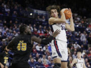 Gonzaga forward Braden Huff (34) grabs a rebound next to Arkansas-Pine Bluff forward Ismael Plet (45) during the second half of an NCAA college basketball game, Tuesday, Dec. 5, 2023, in Spokane, Wash. Gonzaga won 111-71.