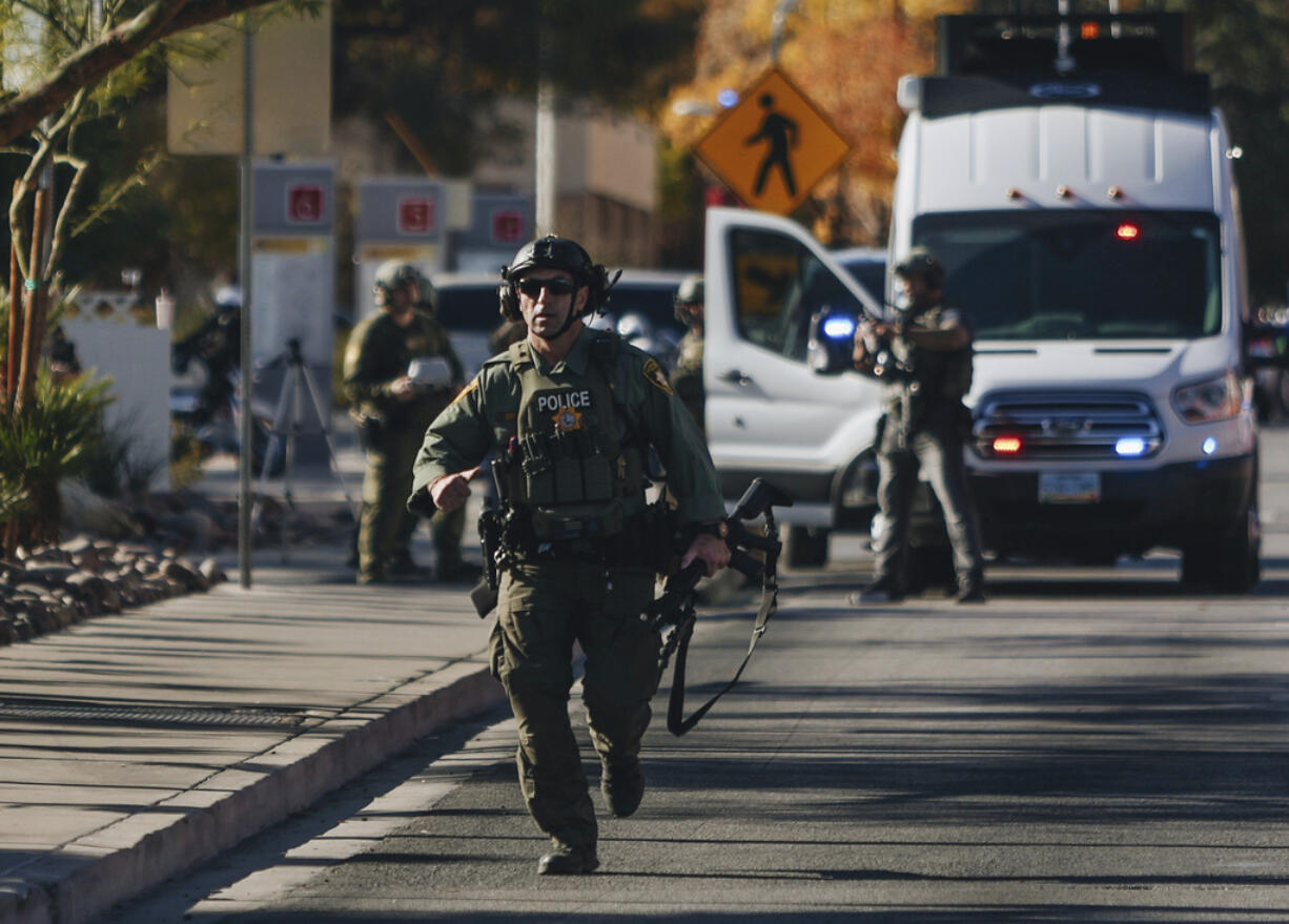 A police officer works the scene of a shooting on the University of Nevada, Las Vegas campus on Wednesday, Dec. 6, 2023, in Las Vegas.