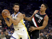 Golden State Warriors guard Stephen Curry grabs a rebound next to Portland Trail Blazers guard Malcolm Brogdon (11) during the first half of an NBA basketball game in San Francisco, Wednesday, Dec. 6, 2023.