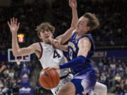 Washington's Moses Wood, right, is fouled by Gonzaga's Dusty Stromer during the first half of an NCAA college basketball game Saturday, Dec. 9, 2023, in Seattle.