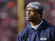 Injured Seattle Seahawks quarterback Geno Smith watches from the sidelline during the first half of an NFL football game against the San Francisco 49ers in Santa Clara, Calif., Sunday, Dec. 10, 2023.