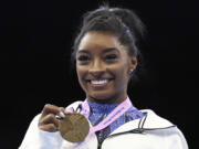 Simone Biles was named the AP Female Athlete of the Year for a third time on Friday, Dec. 22, 2023, after winning national and world all-around titles in her return to gymnastics following a two-year break after the Tokyo Olympics.