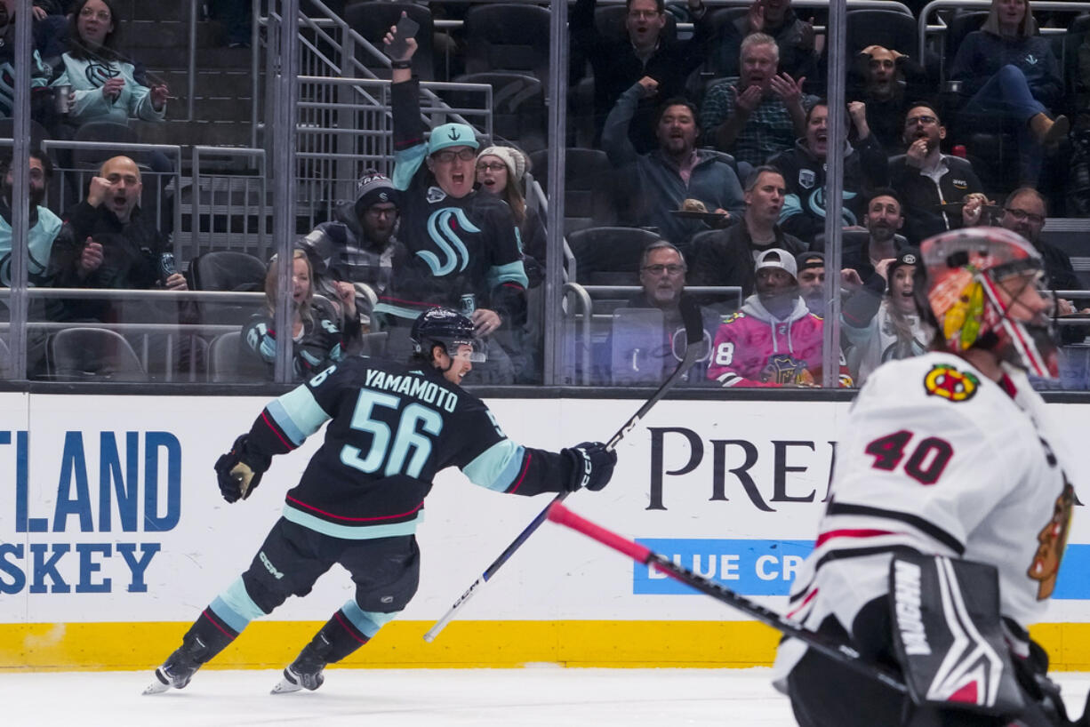 Seattle Kraken right wing Kailer Yamamoto (56) celebrates after scoring against Chicago Blackhawks goaltender Arvid Soderblom (40) during the first period of an NHL hockey game Thursday, Dec. 14, 2023, in Seattle.