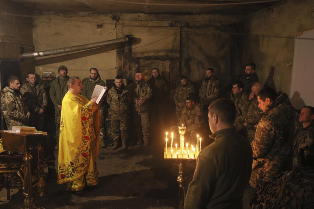 Chaplain Ivan of the Orthodox Church of Ukraine reads a prayer for Ukrainian servicemen of the 72nd mechanized brigade during the sacred liturgy before the upcoming Christmas at the frontline near Vuhledar, Ukraine, Friday, Dec. 15, 2023.