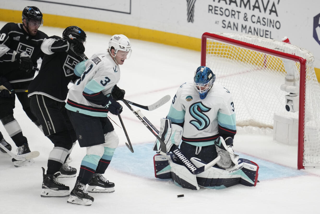 Seattle Kraken goaltender Joey Daccord (35) stops a shot during the second period of an NHL hockey game against the Los Angeles Kings Wednesday, Dec. 20, 2023, in Los Angeles.