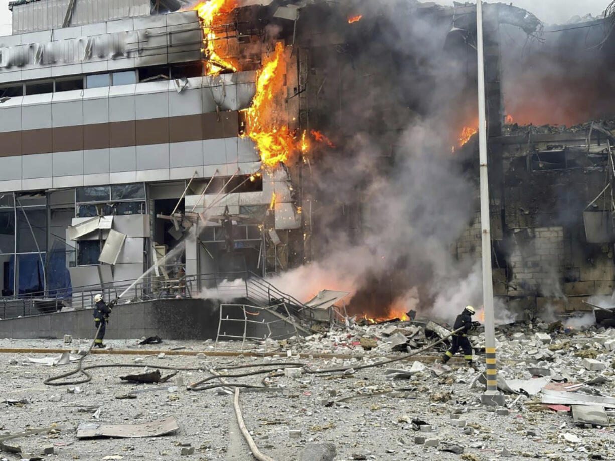 In this photo provided by the Ukrainian Emergency Service, firefighters work on the site of a building damaged after a Russian attack in Kyiv, Ukraine, Friday, Dec. 29, 2023.