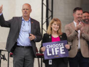 Ohio State Rep. Jennifer Gross, R-West Chester, holding a &ldquo;Choose Life&rdquo; sign, center, joined by Ohio State Rep. Adam Bird, R-New Richmond, left, and Ohio State Rep. Thomas Hall, R-Madison Township, right, stand together on stage during the Ohio March for Life rally at the Ohio State House in Columbus, Ohio, Oct. 6, 2023. The statewide battles over abortion rights that have erupted since the U.S. Supreme Court overturned a constitutional right to the procedure have exposed another fault line: commitment to democracy.