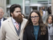 Jennifer Adkins and husband, John, from Caldwell, Idaho talk to the media outside the Ada County Courthouse, Thursday, Dec. 14, 2023 in Boise, Idaho. The two are plaintiffs in a case concerning access to abortive care in Idaho. An attorney for Idaho asked a judge on Thursday to throw out a lawsuit seeking clarity about the medical exemptions to the state&rsquo;s broad abortion bans, saying it was based on hypothetical situations rather than current facts.