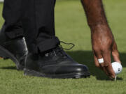 Tiger Woods places his ball on the first tee during the first round of the Hero World Challenge PGA Tour at the Albany Golf Club, in New Providence, Bahamas, Thursday, Nov. 30, 2023.