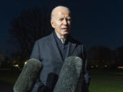 FILE - President Joe Biden answers a reporter&rsquo;s question as he walks from Marine One upon arrival on the South Lawn of the White House, Dec. 20, 2023, in Washington. Biden ordered retaliatory strikes Monday, Dec. 25, against Iranian-backed militia groups after three U.S. servicemembers were injured in a drone attack in Northern Iraq.