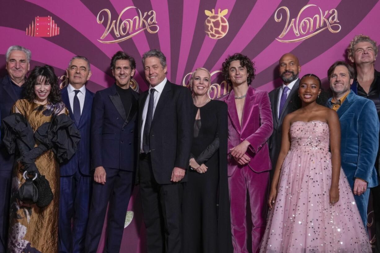 Jim Carter, from left, Sally Hawkins, Rowan Atkinson, Mathew Baynton, Hugh Grant, Olivia Colman, Timothee Chalamet, Keegan-Michael Key, Calah Lane, director Paul King and Simon Farnaby pose for photographers upon arrival at the world premiere of the film &lsquo;Wonka&rsquo; on Tuesday, Nov. 28, 2023 in London.