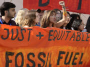 Mitzi Jonelle Tan, of the Philippines, participates in a demonstration with others against fossil fuels at the COP28 U.N. Climate Summit, Wednesday, Dec. 13, 2023, in Dubai, United Arab Emirates.