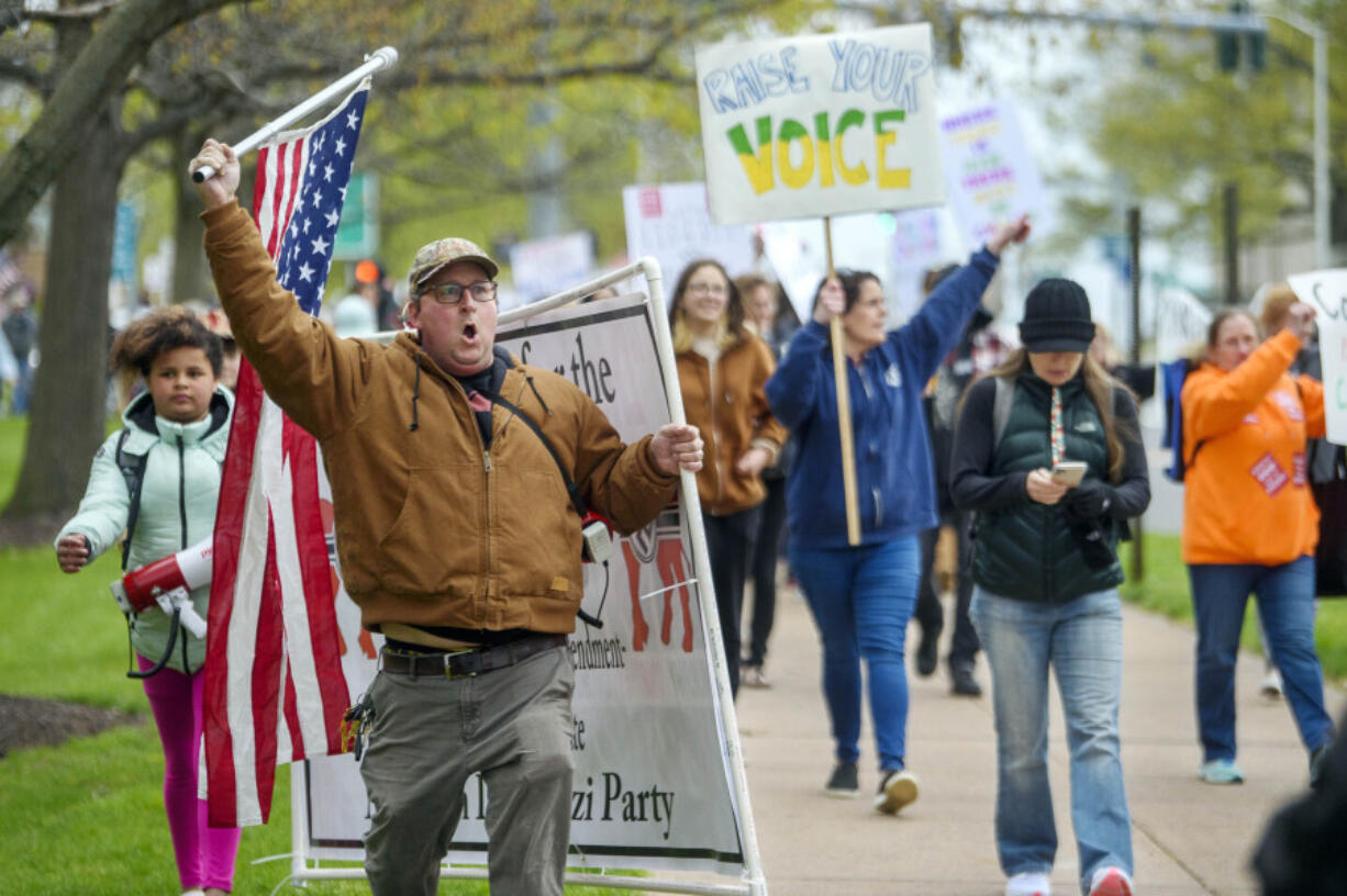 FILE - Opponents of a bill to repeal Connecticut&#039;s religious exemption for required school vaccinations march down Capitol Avenue before the State Senate voted on legislation on April 27, 2021, in Hartford, Conn. Connecticut eliminated its longstanding religious waiver for vaccinations in 2021, joining California, West Virginia, New York and Maine in allowing only medical exemptions.