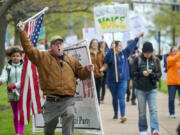 FILE - Opponents of a bill to repeal Connecticut&#039;s religious exemption for required school vaccinations march down Capitol Avenue before the State Senate voted on legislation on April 27, 2021, in Hartford, Conn. Connecticut eliminated its longstanding religious waiver for vaccinations in 2021, joining California, West Virginia, New York and Maine in allowing only medical exemptions.