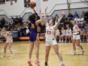 Columbia River's Emma Iniguez (20) takes a shot over Washougal's Bre Alldrin (23) during River's 68-47 win over the Panthers at Washougal High School on Thursday, Dec. 21, 2023.