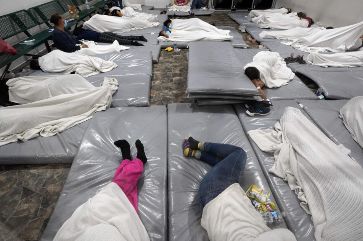 FILE - Women wait in a Border Patrol holding facility Friday, Dec. 15, 2023, in Tucson, Ariz.