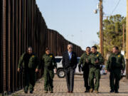 FILE - President Joe Biden talks with U.S. Border Patrol agents as they walk along a stretch of the U.S.-Mexico border in El Paso Texas, Sunday, Jan. 8, 2023. A deal to provide further U.S. assistance to Ukraine by year-end appears to be increasingly out of reach for President Joe Biden. Republicans are insisting on pairing the funding with changes to America&rsquo;s immigration and border policies.