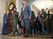 FILE - Ukrainian President Volodymyr Zelenskyy, second from left, walks with Senate Minority Leader Mitch McConnell of Ky., left, and Senate Majority Leader Chuck Schumer of N.Y., right, at Capitol Hill on Thursday, Sept. 21, 2023, in Washington. Congress broke for the holidays, not expected to return for two weeks while continued aid for Ukraine has nearly been exhausted.