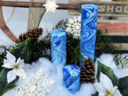 Three blue hand-dyed marbleized candles by Paula Lavender Tucker.