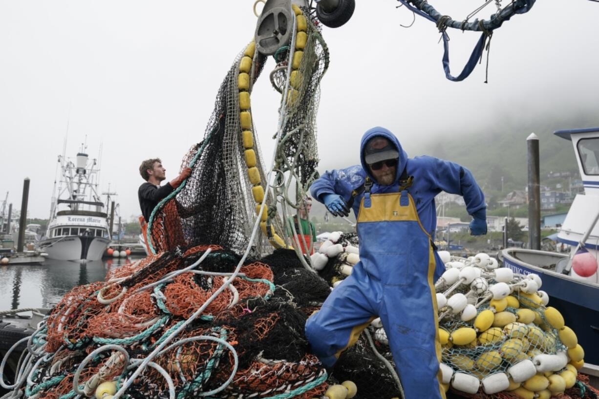 FILE - Salmon fisherman stack their nets on June 22, 2023, in Kodiak, Alaska. A group of lawmakers from New England and Alaska introduced a proposal Thursday, Dec. 7, 2023, that says a federal program that protects the health and wellbeing of commercial fishermen should be expanded to include substance use disorder and worker fatigue. (AP Photo/Joshua A.