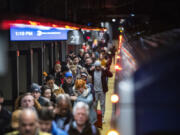 Travelers walk the ramp as they arrive to Grand Central Station in New York, Thursday, Dec. 21, 2023.