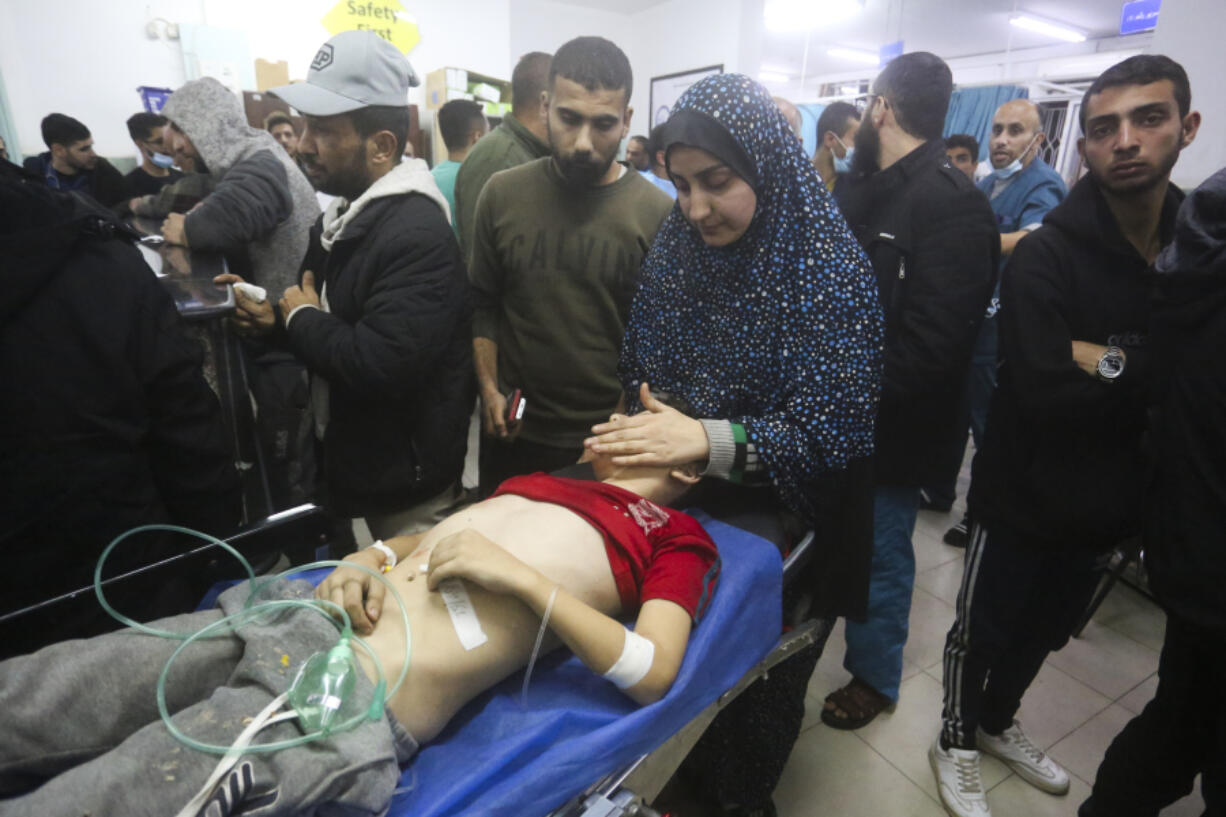 A Palestinian boy wounded in the Israeli bombing of the Gaza Strip is brought to a hospital in Rafah, Thursday, Dec. 28, 2023.