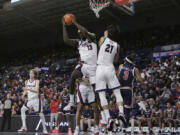 Gonzaga forward Graham Ike (13) grabs a rebound next to Jun Seok Yeo (21) during the second half of an NCAA college basketball game against Jackson State, Wednesday, Dec. 20, 2023, in Spokane, Wash. Gonzaga won 100-76.