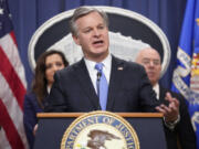 FBI Director Christopher Wray, speaks with reporters during a news conference at the Department of Justice, Wednesday, Dec. 6, 2023, in Washington, as Assistant Attorney General Nicole M. Argentieri of the Criminal Division, left, and Secretary of Homeland Security Alejandro Mayorkas, look on.