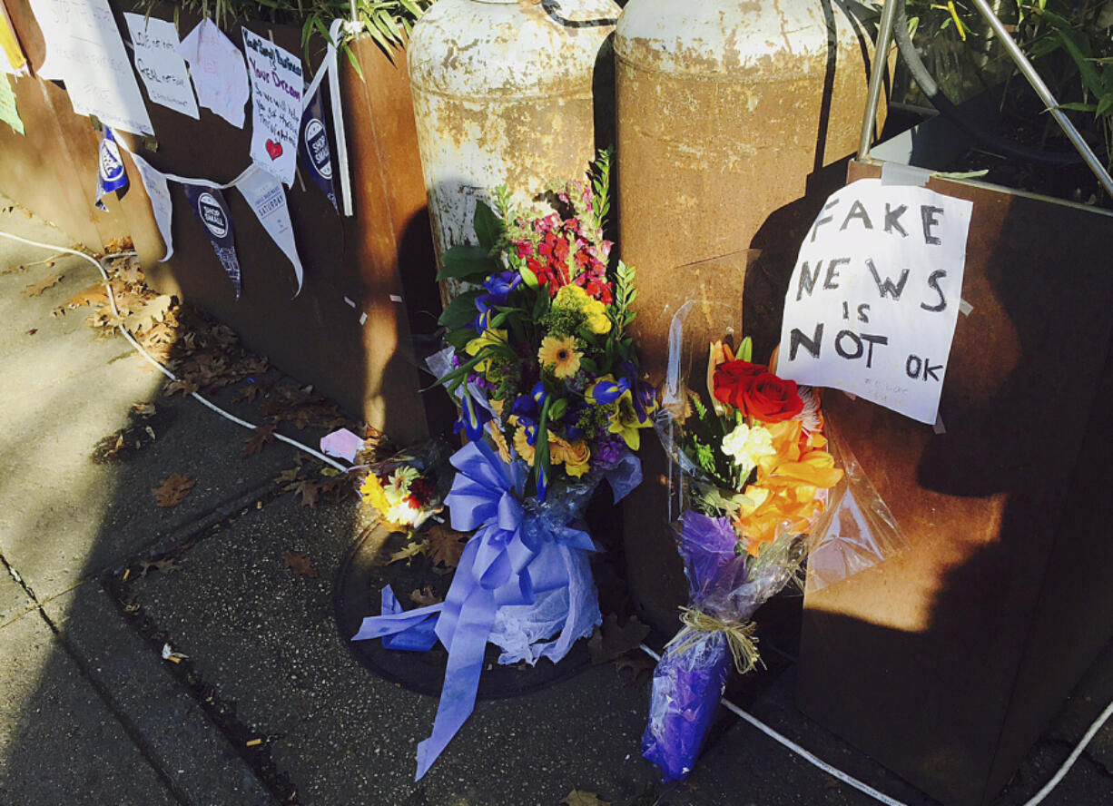 FILE - In this Dec. 9, 2016 photo, flowers and notes left by well-wishers outside a pizza restaurant in northwest Washington, D.C.,are shown, where a North Carolina man fired an assault rifle multiple times as he attempted to &ldquo;self-investigate&rdquo; the conspiracy theory known as &ldquo;Pizzagate. On Friday, Dec. 1, 2023, The Associated Press reported on stories circulating online incorrectly claiming an expert who debunked the &ldquo;pizzagate&rdquo; conspiracy theory has been jailed for possessing child sexual abuse images.