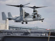 FILE - A Marines Osprey lands aboard the USS Somerset, Feb. 27, 2014, in Philadelphia.  A congressional oversight committee has launched an investigation into the V-22 Osprey program following the latest deadly crash,  which killed eight Air Force special operations service members. The entire Osprey fleet remains grounded following the crash, with the exception of some limited Marine Corps flights.