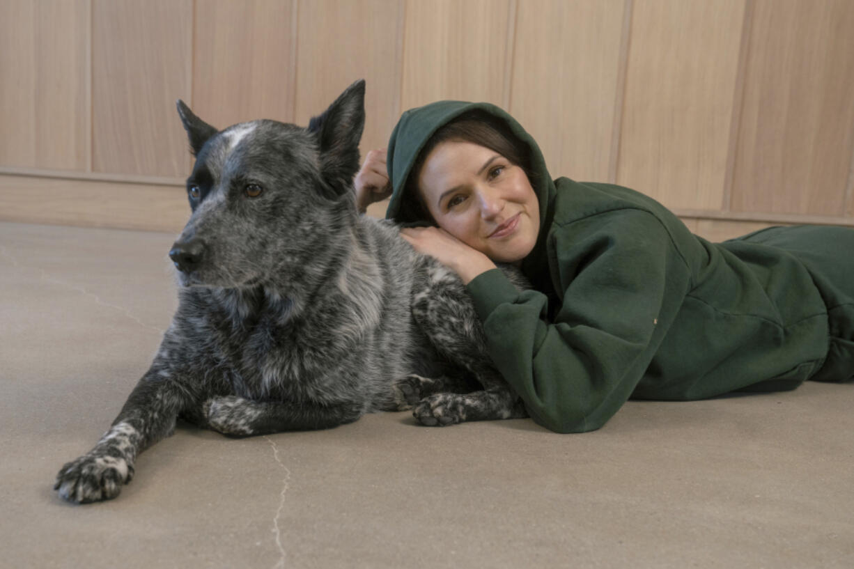 Adriene Mishler poses with her dog, Benji, in Austin, Texas on Nov. 29, 2022. Mishler received Benji as a gift as a puppy from her then-boyfriend soon after losing a beloved dog.