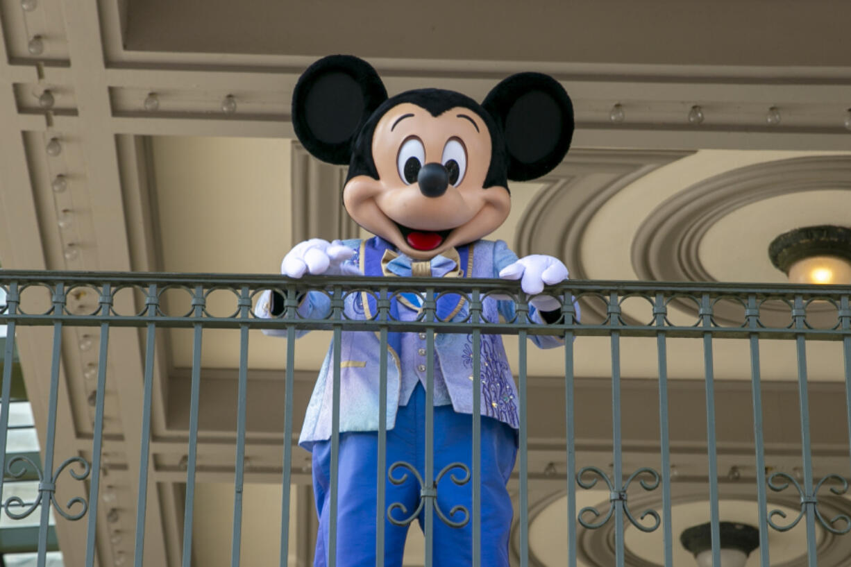 FILE - An actor dressed as Mickey Mouse greets visitors at the entrance to Magic Kingdom Park at Walt Disney World Resort, April 18, 2022, in Lake Buena Vista, Fla. The earliest version of Disney&#039;s most famous character, Mickey Mouse, and arguably the most iconic character in American pop culture, will become public domain on Jan. 1, 2024.