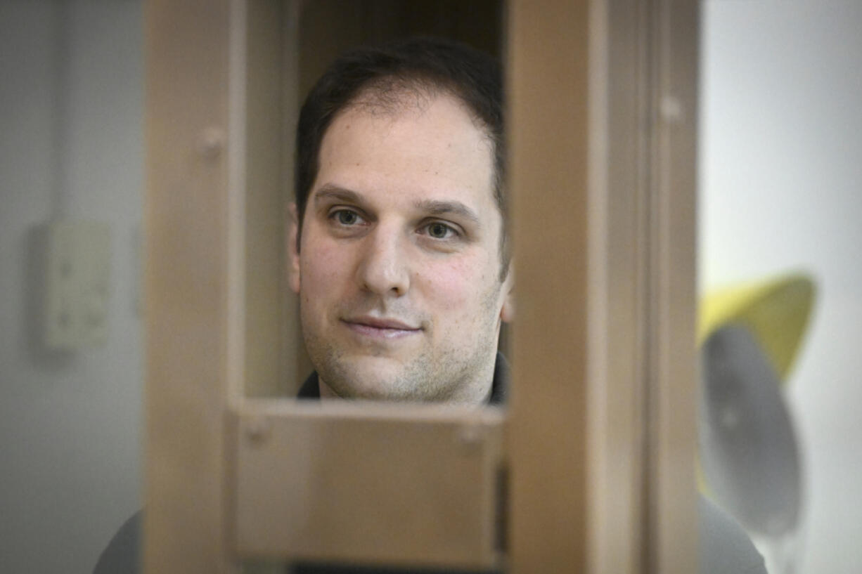 Wall Street Journal reporter Evan Gershkovich stands in a glass cage in a courtroom at the Moscow City Court, in Moscow, Russia, on Thursday, Dec. 14, 2023. Wall Street Journal reporter Evan Gerhskovich, arrested in Russia on espionage charges, will remain in detention until Jan. 30, a court in Moscow ruled on Thursday. The hearing took place behind closed doors because authorities say details of the criminal case against the American journalist are classified.