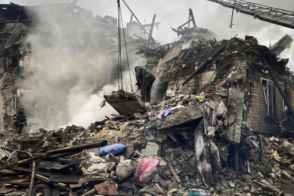 In this photo provided by the Ihor Moroz, Head of the Donetsk Regional Military Administration, rescuers work at the scene of a building damaged by shelling, in Novogrodivka, Ukraine, Thursday, Nov. 30, 2023.