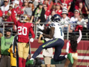 Seattle Seahawks wide receiver DK Metcalf, right, has made as much news for his frustration as his play. (Godofredo A.