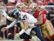 Seattle Seahawks quarterback Drew Lock, foreground, reaches for the ball in front of San Francisco 49ers defensive end Chase Young, right, and defensive end Nick Bosa on a failed two point conversion attempt during the second half of an NFL football game in Santa Clara, Calif., Sunday, Dec. 10, 2023.